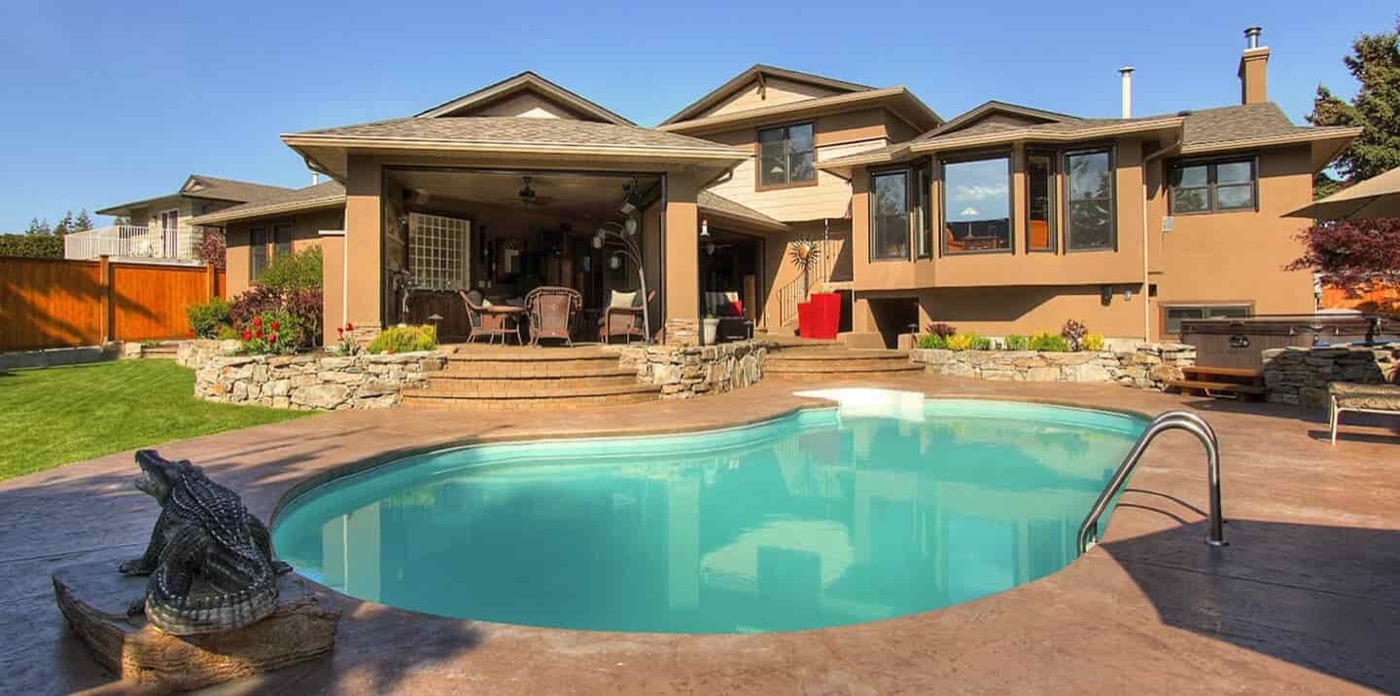 Backyard pool patio with stone hardscaping and outdoor living space