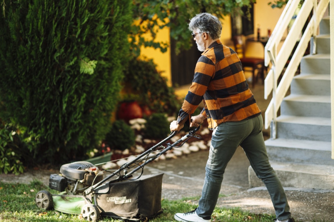 Professional landscaper maintaining a lush green lawn
